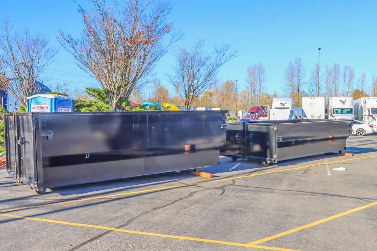 Professional dumpster rental service with roll-off container on residential driveway in Temple